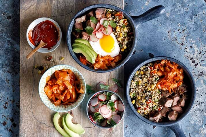 Carne Asada Bibimbap with Fiesta Rice Gochujang Salsa and Fried Egg Recipe Image
