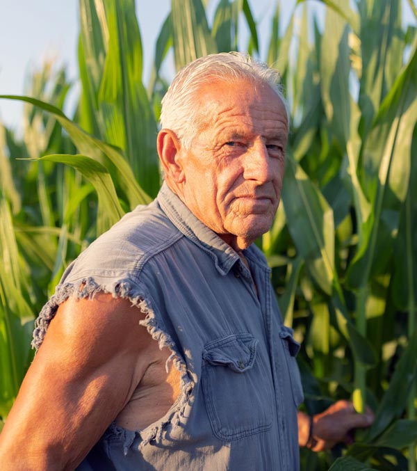 Farmer stands near his cornfield