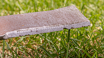 Close up of dented mower blade