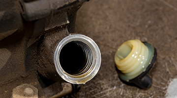 Oil cap removed from lawnmower