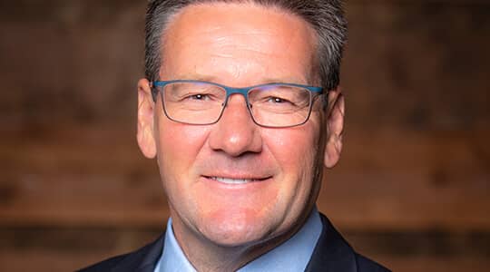 Portrait of Mr. Garrett Lofto,  President and Chief Executive Officer (CEO), Director and Executive Committee member of the J.R. Simplot Company.