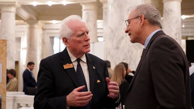 Rick Phillips visits with a legislator
