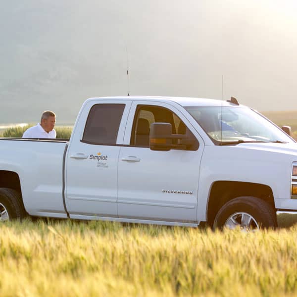 Simplot Grower Solutions pickup truck in a field