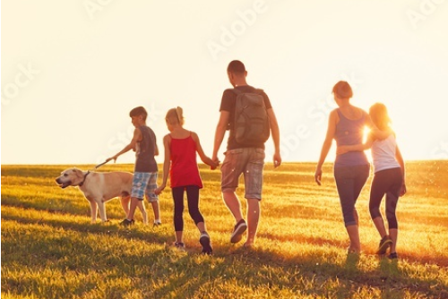 Family walking together at sunset